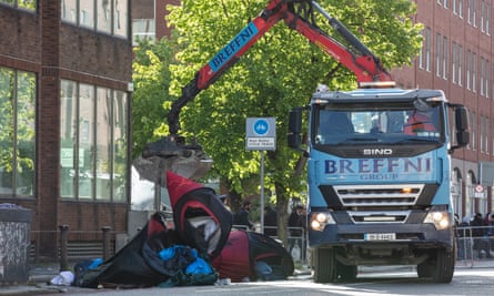 A van with a crane lifts up tents