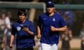 Los Angeles Dodgers' Shohei Ohtani, right, jogs on to a practice field with his former interpreter Ippei Mizuhara before news of the scandal broke