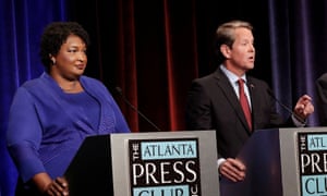 Stacey Abrams with Brian Kemp before the 2018 midterms. In the gubernatorial election, Abrams accused Kemp of voter suppression.