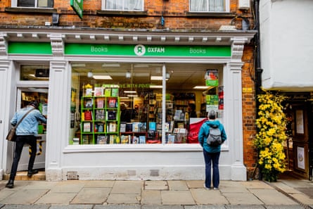 woman standing outside of the Oxfam bookshop store front