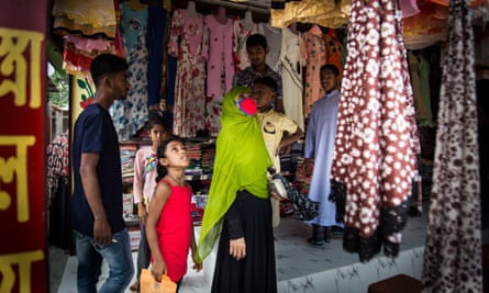 Tasnia and her daughter shopping in the village market before Eid.