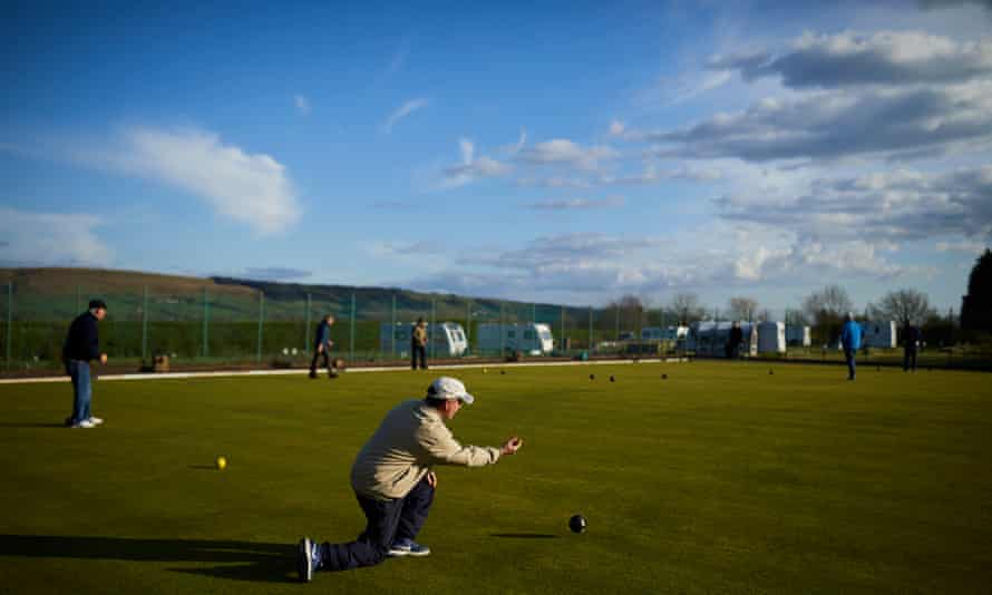 A group of men playing bowls