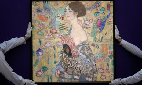 Employee position an artwork entitled 'Dame mit Facher (Lady with a Fan)' by Austrian artist Gustav Klimt
