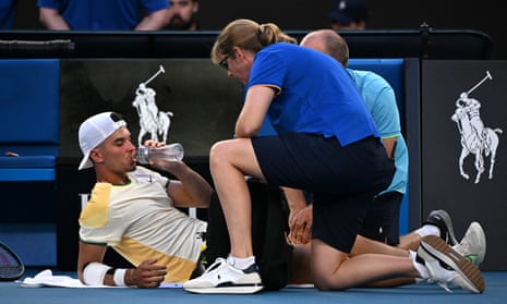 Dino Prizmic receives treatment during his men's singles match against Novak Djokovic on day one of the Australian Open in Melbourne