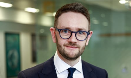 Formal photograph of Chris Stark in a. suit and tie