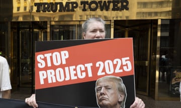 An anti-Trump protester with organization Rise and Resist holds a sign with an image of former President Trump that reads 'STOP PROJECT 2025' at the entrance to Trump Tower on Fifth Ave on 10 July.