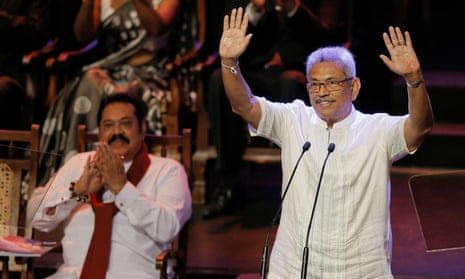 The SLPP’s presidential candidate, Gotabaya Rajapaksa, waves to party members while his brother, Mahinda Rajapaksa, applauds