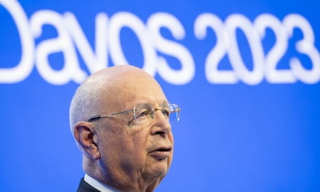 Klaus Schwab with the blue and white Davos 2023 sign behind him