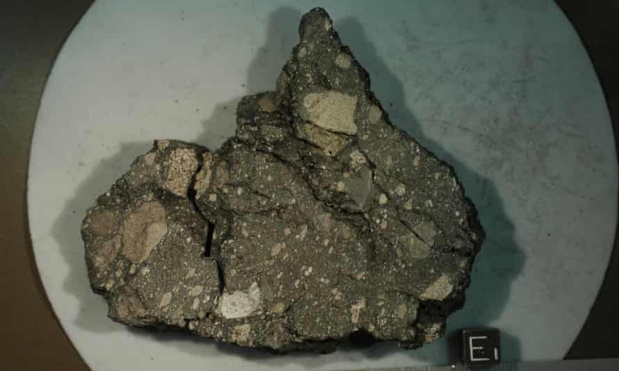 The lunar rock sample from the Apollo 15 mission. The rock consists of basalt fragments welded together by a dark glassy matrix produced by melting caused by a meteorite impact.