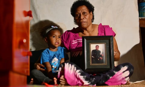 Nainasa Valetabua with her three-year-old grand-daughter Marica Duikoro at her home in Lami, Fiji. She hold a picture of her son, Taitusi Ratucaucau, a British Army veteran whose life is in limbo since his contract was terminated. 