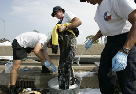 A person being washed down with bleach and water.