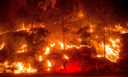 A firefighter helps ignite a backfire while battling the Rocky fire near Clearlake, California, on Sunday. 