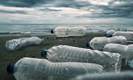 Plastic water bottles on a beach.
