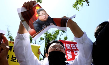A North Korean refugee tears a portrait of Kim Jong-un during a rally in May in Seoul, South Korea. 