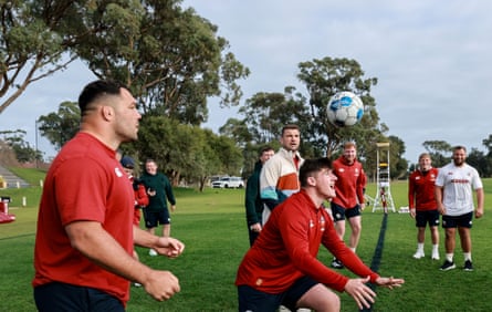 Ellis Genge (left) watches Dan Sheehan head a football as the Lions train in Perth