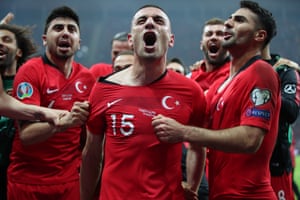 Turkey’s Merih Demiral, centre, celebrates with teammates after Turkey secured qualification for the Euro 2020 finals.