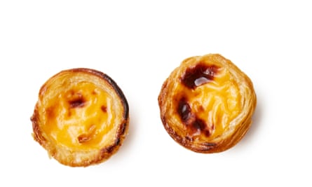 fill the cases by three-quarters with custard. Working quickly, put the tins on the hot sheets and bake for about 10 minutes, until the pastry is dark golden and the custard starting to brown in spots
