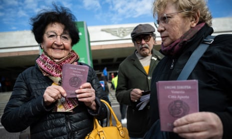Members of Venice Arci Association (ARCI) hold fake passports as they demonstrate against the new ticket access outside the Santa Lucia railway station in Venice, as visitors entering the UNESCO World Heritage site for one day have to buy a five-euro ($5.3) ticket in Venice.