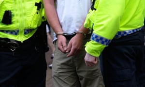 Officers handcuff and detain man.