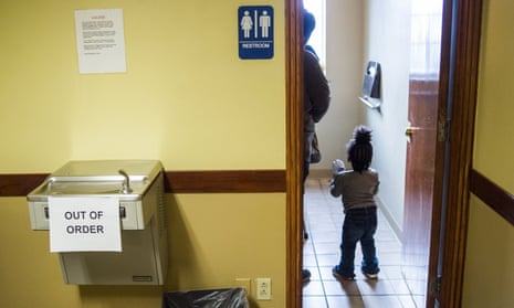 Ombi Wilbert, 1, walks into the bathroom to wash her hands after passing by an out of order water fountain before receiving a free lead test on Monday, Feb. 8, 2016 at Carriage Town Ministries in Flint, Mich. Molina Healthcare provided children up to six years of age with free lead testing, as well as water filters for families to take home and install. (Jake May/The Flint Journal-MLive.com via AP)