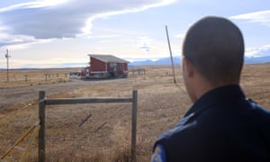 Police officer Isaiah Webber outside one of the reservation’s ‘party houses’, one of the last places Ashley Heavyrunner Loring was seen.