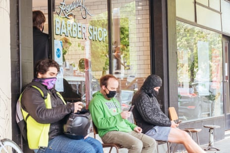 Men queue up for a haircut in Rathdowne St Carlton, after hairdressers are allowed to reopen during the coronavirus pandemic and associated lockdown. Coronavirus outbreak, Melbourne, Australia, on 25 October 2020.