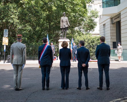 a group of people standing in front of a statue of charles de gaulle