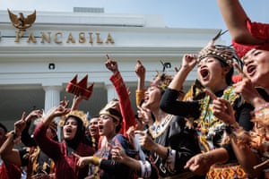 Performers react to music by the Pancasila building in Jakarta