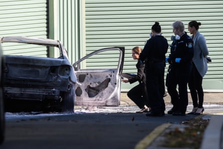 Forensic police and detectives at the scene of a burnt out car Zetland, Sydney, Australia in June 2023