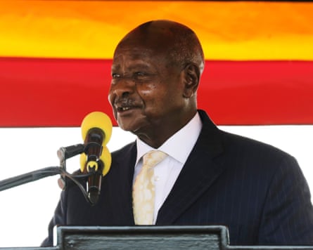 a black african man wearing a suit talking into a microphone