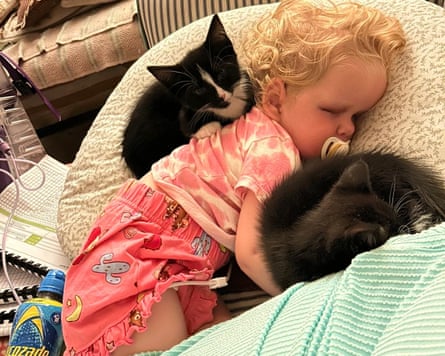 Elsie at home with two kittens in June.