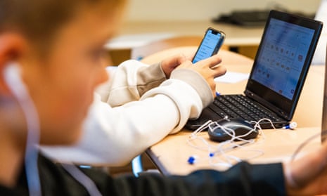 Children with their smartphones in school