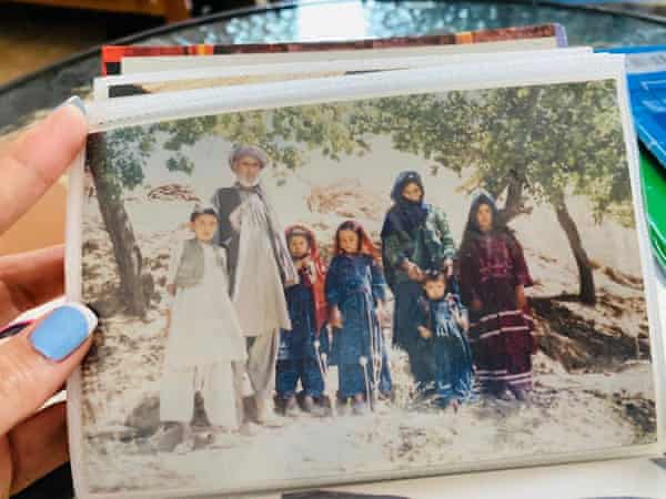 Gulafroz holds a family photograph, taken in Afghanistan