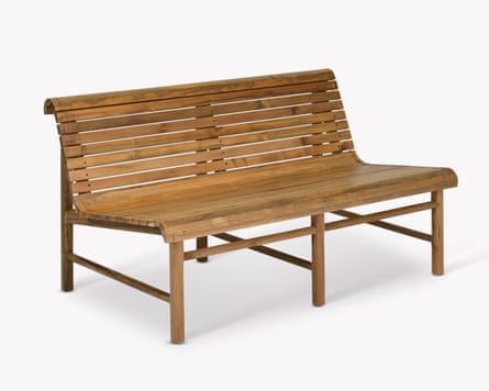 A wooden outdoor bench made out of teak. There are small gaps between the wooden slats.