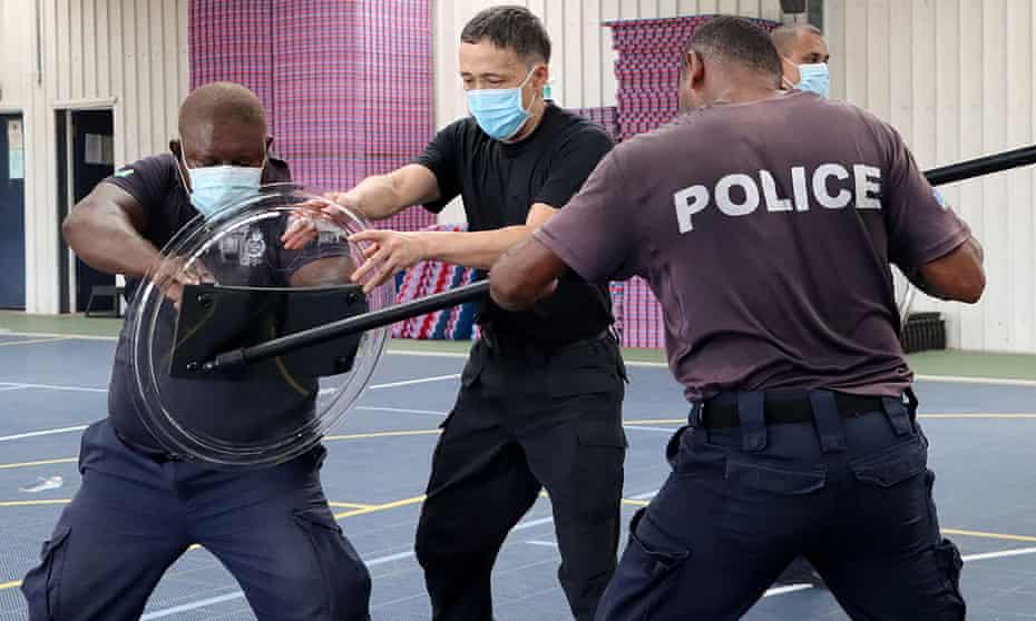 A Chinese police officer trains Solomon Islands police in unarmed combat skills