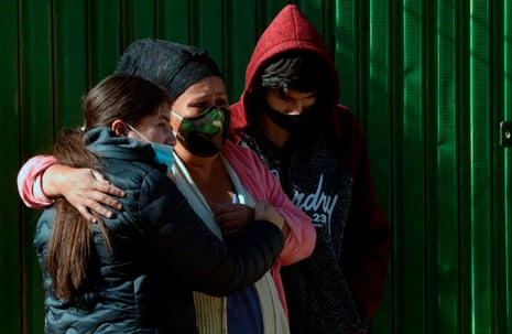 Relatives of a victim of Covid-19 who had left his remains for a week in the street as they had not been able to bury him in Cochabamba, Bolivia on 4 July, 2020.