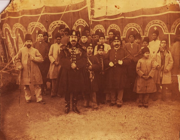 This 1895 photo was taken by one of the most important photographers of the Qajar era, Abdullah Qajar (1850-1909). In this rare photo, Nasser al-Din Shah is accompanied by his sons, members of court, and most of his favourite and influential slaves. There are 10 African eunuchs in the photo, among them Haji Firouz (the one wearing white and standing behind the king) who was one of the most trusted slaves of the king. Outside one of the royal tents, Norouz 1895 (Iranian New Year), possibly Shahrestanak, Tehran.
