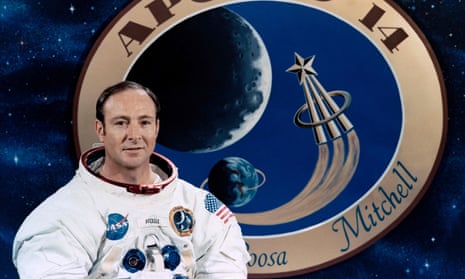 Edgar Mitchell, posing in front of a graphic of the Apollo 14 mission patch.
