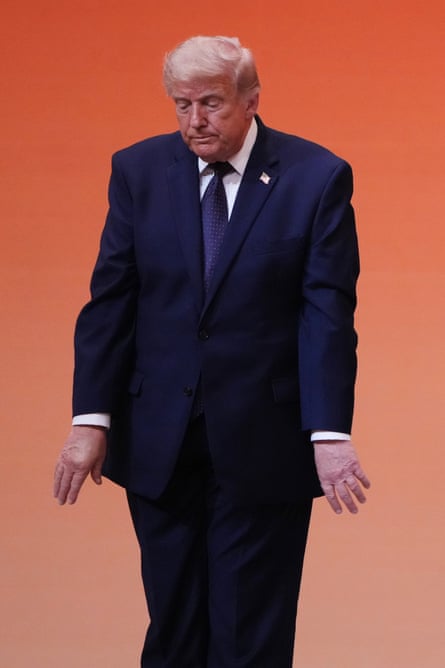 a man in a suit stands awkwardly