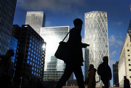 they are seen from a low viewpoint as near-black shadows against the backdrop of skyscrapers and tall towers and a clear, blue sky.