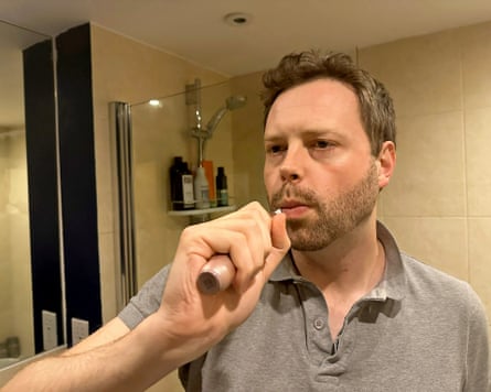 Alan brushing his teeth in his bathroom