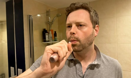 Alan brushing his teeth in his bathroom