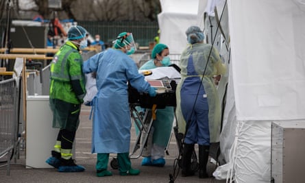 Health workers attend a patient at an emergency field hospital in March in Lombardy, Italy