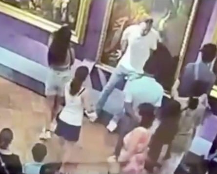A barbarian horde? … A tourist damages a painting at the Uffizi Gallery, Florence, in images taken from an exclusive video by TG1.