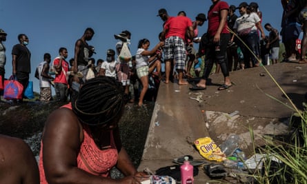 Migrants near the International Bridge in Del Rio on Thursday.
