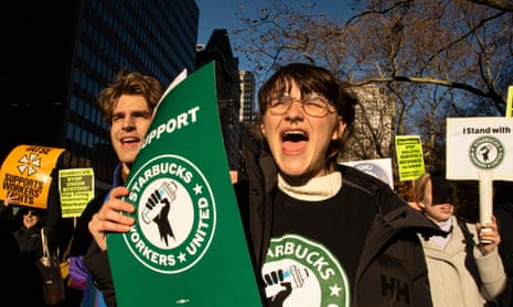Starbucks workers and supporters rally at city hall in New York in December.