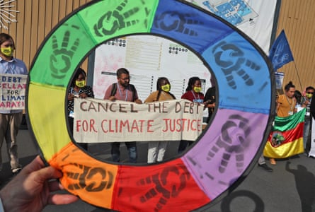 Climate activists hold up a banner demanding the cancellation of developing nations’ debts at the Cop27 climate conference in Sharm el-Sheikh in November 2022.