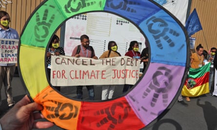 Climate activists hold up a banner demanding the cancellation of developing nations’ debts during the Cop27 climate conference in Sharm el-Sheikh, Egypt last November.