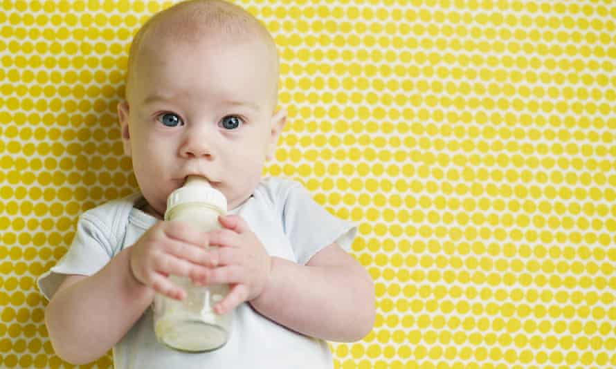 A baby drinking from a bottle.