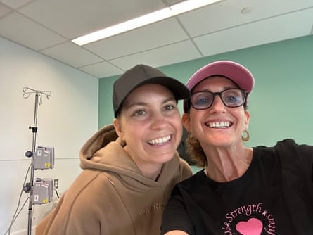 Two women wearing hats and smiling in a doctor’s office